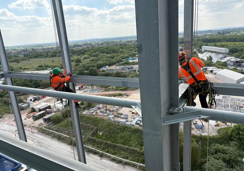 Group of workers working on steel using rope access