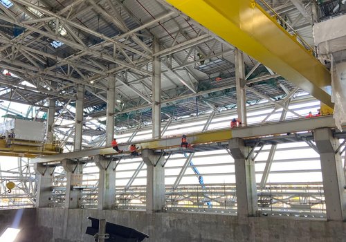 4 men working with steel using rope access