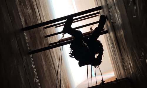 Rope access technician in a hard to reach area