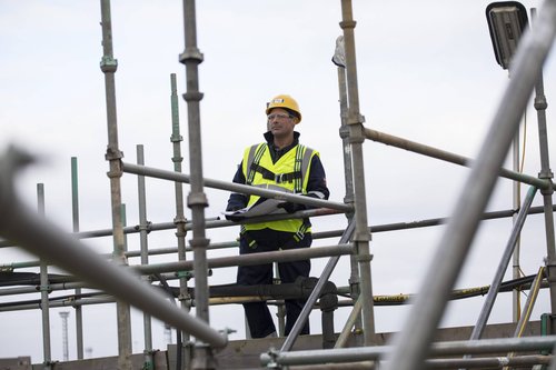 Site surveyor on scaffolding